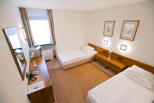 Säng eller sängar i ett rum på Hotel Laguna Zagreb