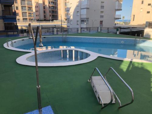 an empty swimming pool with two slides in the water at Miraplaya in Benicàssim