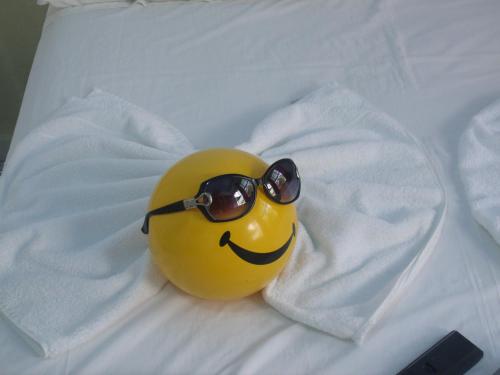 a yellow rubber duck with sunglasses on a bed at Pousada Edson in Caraguatatuba