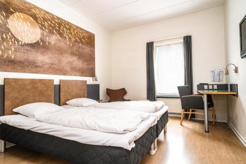Postel nebo postele na pokoji v ubytování City Hotel Nattergalen