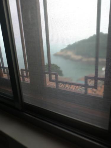 a window with a view of a body of water at mei hao min su in Nangan