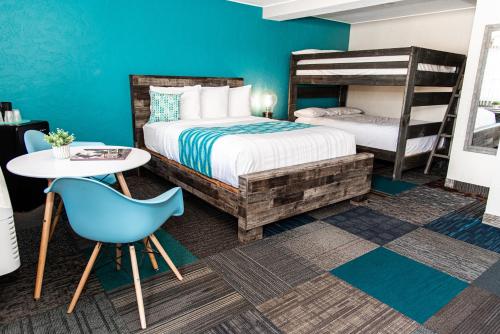 a bedroom with two bunk beds and a table and chair at American Classic Inn in Salida