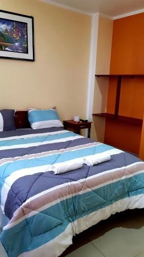 a bedroom with two beds with towels on them at Hostal Capac in Ayacucho