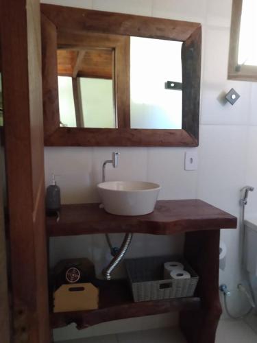 a bathroom with a sink and a mirror at POUSADA BELA HELENA in Visconde De Maua