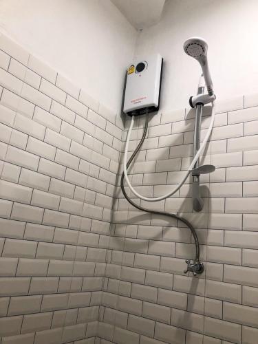 a shower head on a wall in a bathroom at Saffron Hill Bangkok in Bangkok