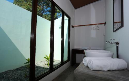 a bathroom with a sink and a large window at Rafflesia Resort in Lundu