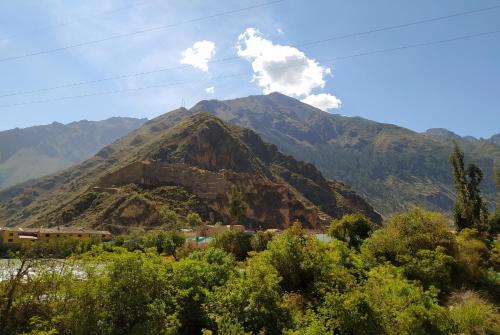 a mountain with smoke coming out of it at Tambo de Ollantay Hotel in Ollantaytambo
