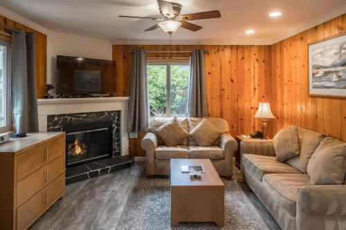 a living room with a couch and a fireplace at Andril Fireplace Cottages in Pacific Grove