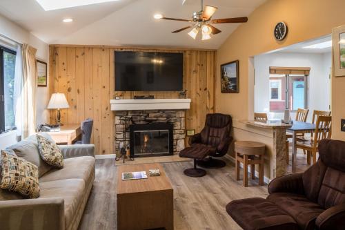 a living room with a couch and a fireplace at Andril Fireplace Cottages in Pacific Grove