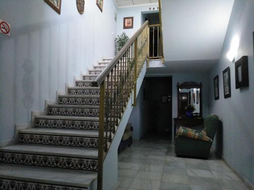 a staircase in a house with a stair case at Hostal El Polígono in Lucena
