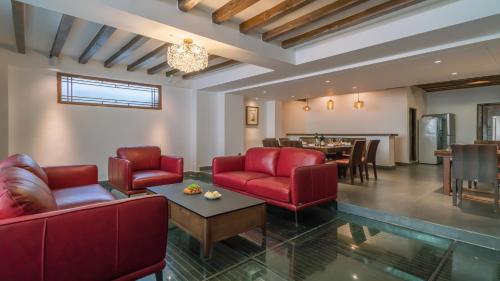 a living room with red chairs and a table at Artistic-Suite in Lijiang