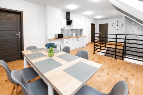 uma cozinha e sala de jantar com mesa e cadeiras em Pokoje Gościnne TOPOLA em Kudowa-Zdrój