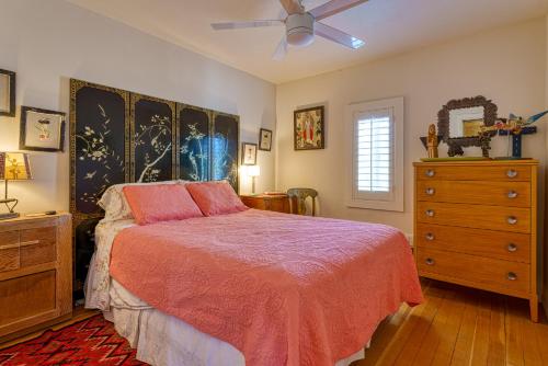 a bedroom with a bed and a dresser and a ceiling fan at Cactus Adobe in Twentynine Palms