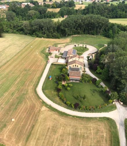 an aerial view of a large house on a field at La Rondanina in Castelnuovo Fogliani
