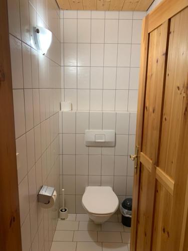 a small bathroom with a toilet and a light at Ferienhaus am Burgsee in Ladis