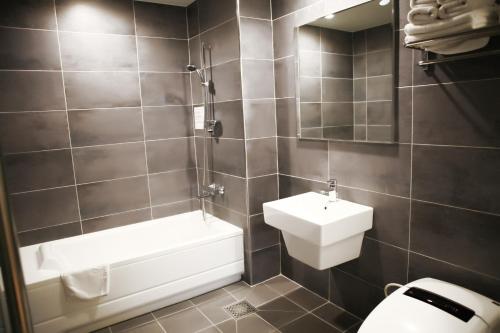 a bathroom with a white toilet and a sink at Incheon Stay Hotel in Incheon