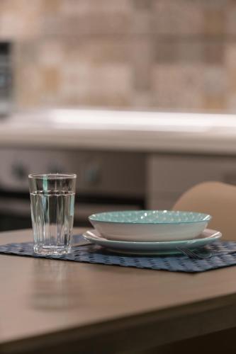 a table with two plates and a glass on it at Casa Leone, cosy apartment overlooking the square in Spílion