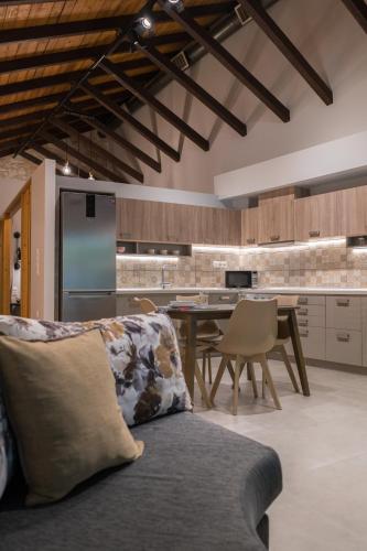 a kitchen with a couch and a table and a refrigerator at Casa Leone, cosy apartment overlooking the square in Spílion