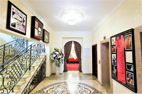 a hallway with a staircase with a vase of flowers at Boutique Hotel California in Odesa