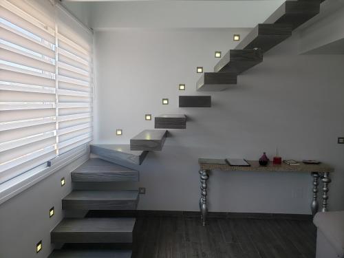 a staircase in a house with a table next to it at Loft of Love in Frigiliana