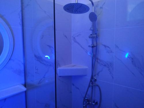 a bathroom with a shower with a sink and a shower at Art Studios Benitses in Benitses