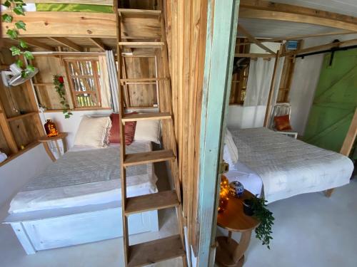 a room with two bunk beds and a ladder at Memo's Beach in Nilaveli
