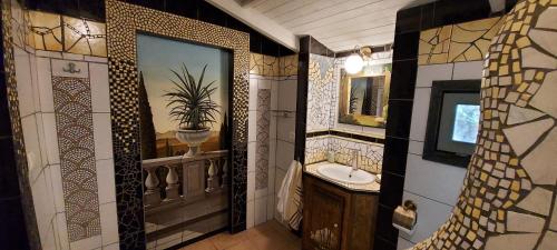 a bathroom with a sink and a mirror at Varias Art House in Kallirákhi