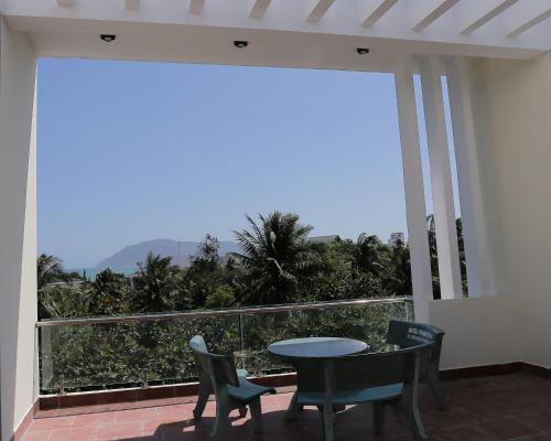a balcony with a table and chairs and a view at Thanh Trang Hotel in Con Dao