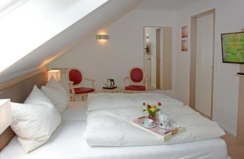 a bedroom with a bed with a tray of flowers on it at Der Eichenhof in Hellwege