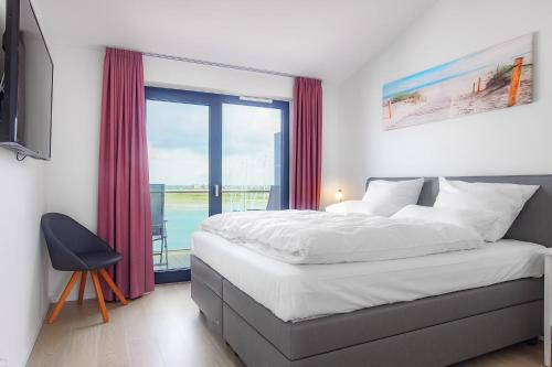 Postel nebo postele na pokoji v ubytování Hafenspitze Heiligenhafen No4