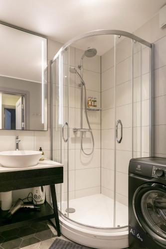 a bathroom with a shower and a sink at Brand New, Family-friendly with a great location - Moon Apartment in Ventspils