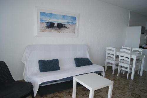 uma sala de estar com um sofá, uma mesa e cadeiras em Torre Luquillo em La Manga del Mar Menor