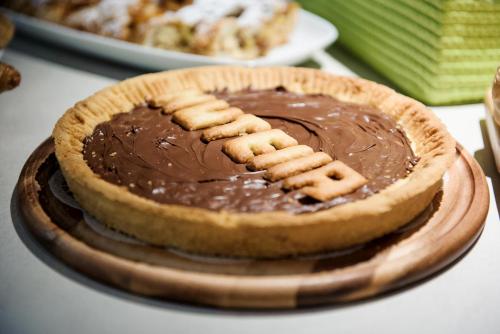 a chocolate pie with a football cookie on top at Hatelier Garda Home by Enjoy Garda Hotel in Peschiera del Garda