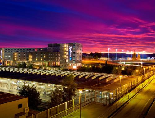 a city with a train station at night at Radisson Blu Airport Hotel, Oslo Gardermoen in Gardermoen