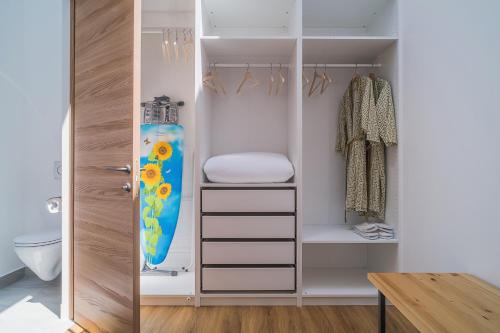 a walk in closet with a surfboard in it at Rooms for rent on 51 Svetlanskaya street in Vladivostok
