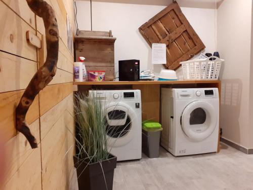 a laundry room with a washer and a washing machine at "CASABANA" - relax tutto l'anno - giardino - piscina Top in Malcesine