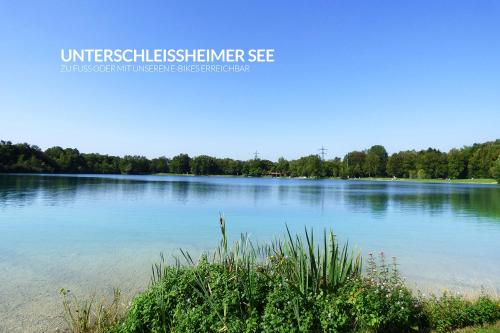 a large body of water with trees in the background at Infinity Hotel & Conference Resort Munich in Unterschleißheim