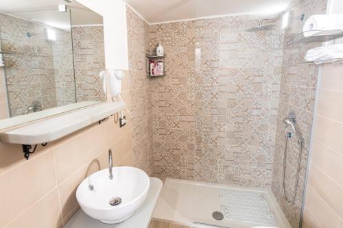 a bathroom with a sink and a toilet and a shower at Sette Torri - Affittacamere in Molfetta