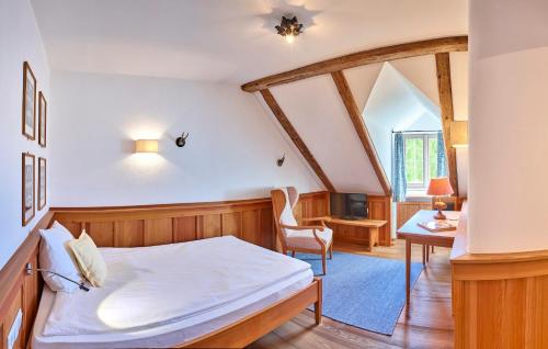 a bedroom with a bed and a table and a chair at Romantik Hotel Zum Klosterbräu in Neuburg an der Donau