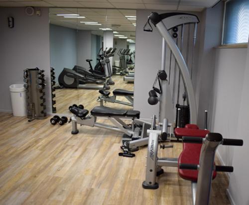 a gym with a bunch of treadms and machines at Bilderberg Parkhotel Rotterdam in Rotterdam