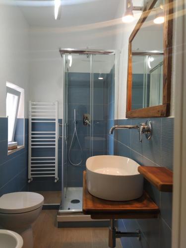 a bathroom with a sink and a toilet and a shower at Judia Camere sul mare in Maratea