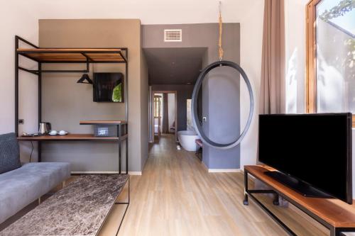 a living room with a couch and a tv at Antico Borgo di Sutri in Sutri