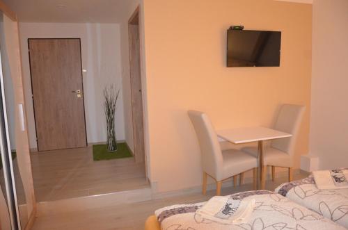 a small room with a table and a table and chairs at penzion U Koníčka in Strážiště
