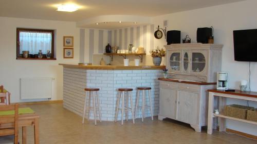 a kitchen with a bar and stools in a room at Słoneczna Ostoja in Mikołajki