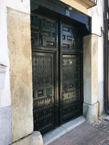 a pair of black doors on a building at Casa San Roque in Chinchón