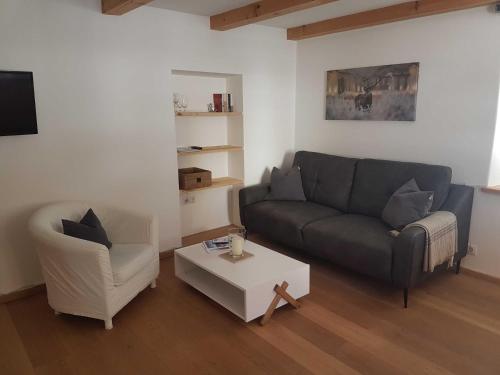 a living room with a couch and a coffee table at Ferienwohnungen Garhammer_ Kreuth_ in Kreuth