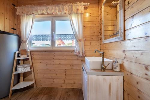 a bathroom with a sink and a window at Arctic House in Dolný Kubín