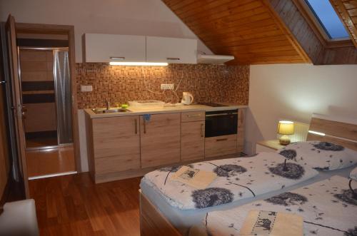 a kitchen with two twin beds in a room at penzion U Koníčka in Strážiště