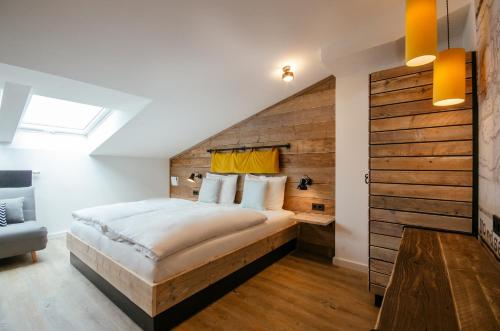 a bedroom with a large bed with a wooden wall at Hotel Landhafen in Niebüll