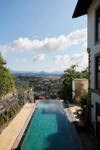 a swimming pool on the side of a building at Boutique Hotel Mendi Argia in Donostia-San Sebastián